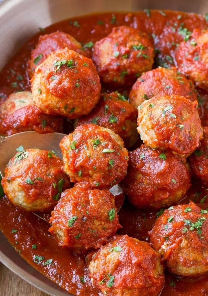 Meatballs in rich tomato sauce garnished