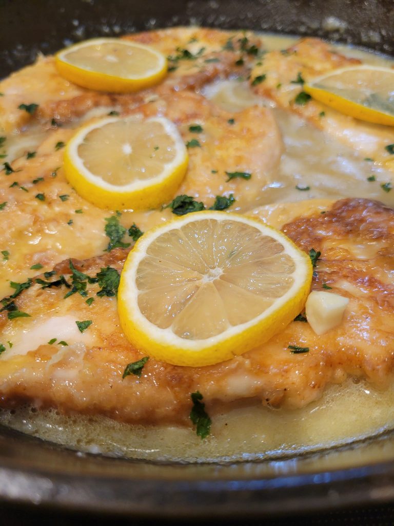 Lemon chicken simmering in butter sauce